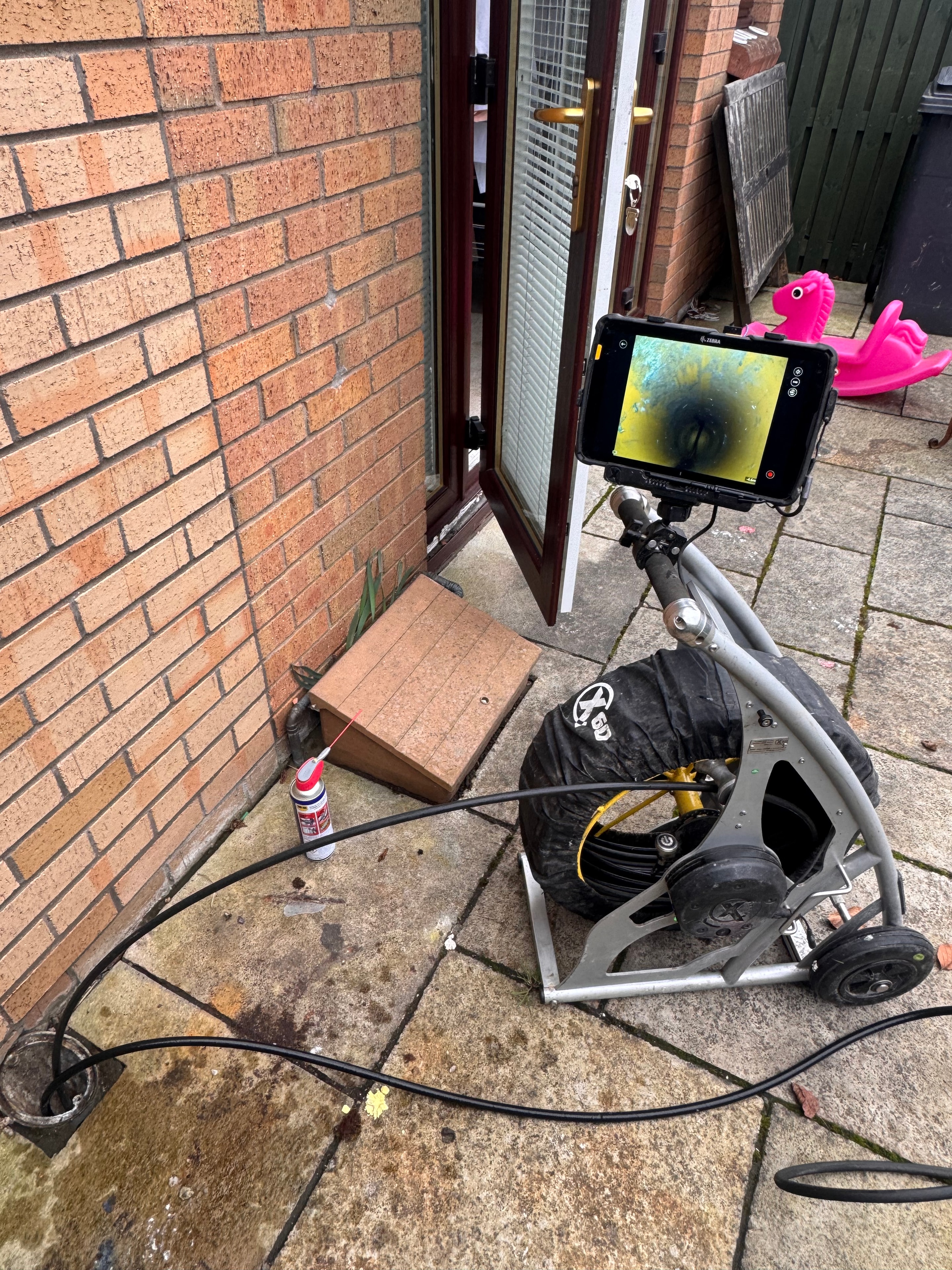 Drainage technician carrying out a CCTV drain survey at a residential property